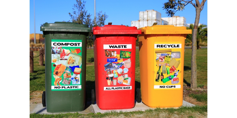 Three recycling bins remind us to sort recycling properly. 