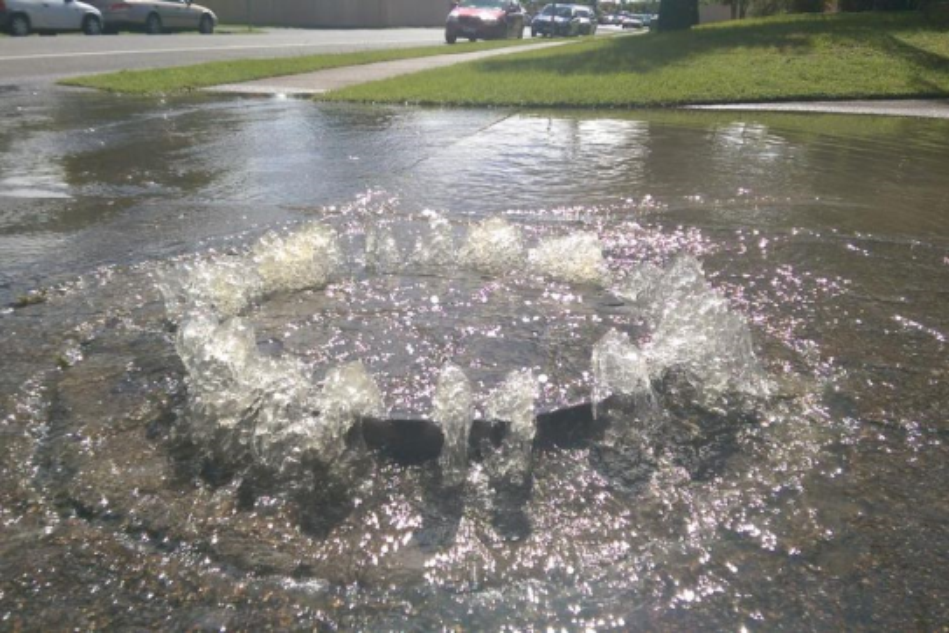 Wastewater spills from a manhole cover during a wet weather event.